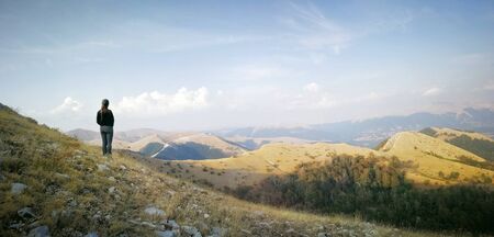 Pescasseroli (AQ), Italy - August 31, 2017: A woman admires the summer landscape from a mountain...