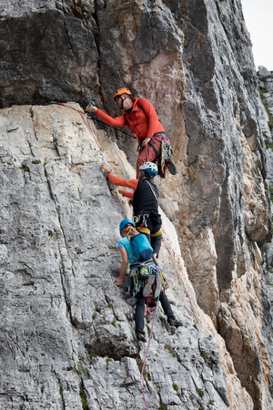 Cortina d'Ampezzo, Italy - August 17, 2018: some climbers climb with their bare hands and with ropes, on top of a rocky wall. Location Cinque Torri, Dolomites.のeditorial素材