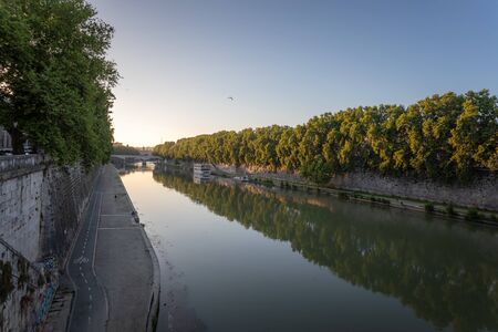 Panoramic view of the Tiber river with its imposing embankments and surrounding vegetation. At the bottom left the bike path that runs along the river.の写真素材