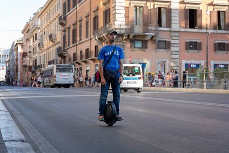 Rome, Italy - August 15, 2019: A man circulates on an electric unicycle on the streets of the city center. Electric vehicle, sustainable mobility of people. Innovative urban transport.のeditorial素材