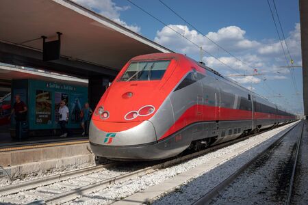 Naples, Italy - 11 September 2019: High-speed train arrives and stops at the railway central station platformのeditorial素材
