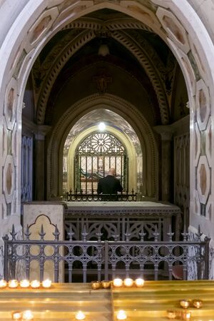 Assisi, Italy - December 7, 2019: Inside the church there is the original crypt with the remains of St. Clare, enclosed in a body-reliquary, which lies inside a crystal urn.のeditorial素材