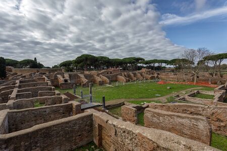 Ruins of Ostia Antica, large ancient Roman archaeological site near the modern city of Ostia, 25 kilometers from Rome, Italy. Roman necropolis, decumani, statues, columns and ancient ruins in the archaeological park.の写真素材
