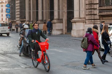 Rome, Italy - February 15, 2020: A man rides in the city center on Jump bicycle, Huber's new rental bicycle service.のeditorial素材