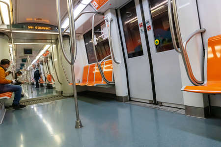 Rome, Italy - April 30, 2020: Inside the metro of line A the seats remain empty due to the quarantine imposed by the coronavirus emergency. Few passengers traveling.のeditorial素材