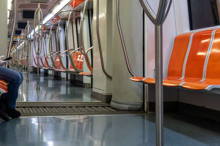 Rome, Italy - April 30, 2020: Inside the metro of line A the seats remain empty due to the quarantine imposed by the coronavirus emergency. Few passengers traveling.のeditorial素材