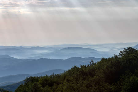 From the top you can see an expanse of mountain peaks that get lost on the horizon between the fog...
