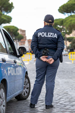 Rome, Italy - October 9, 2020: policeman on patrol with Italian police car, in checkpoint in the city.のeditorial素材