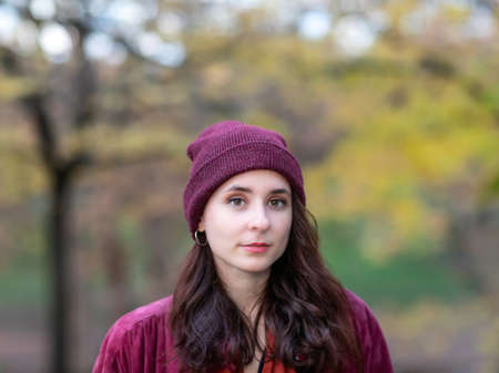 Portrait of girl in autumn nature foliage.