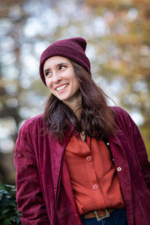 Portrait of girl in autumn nature foliage. Half body