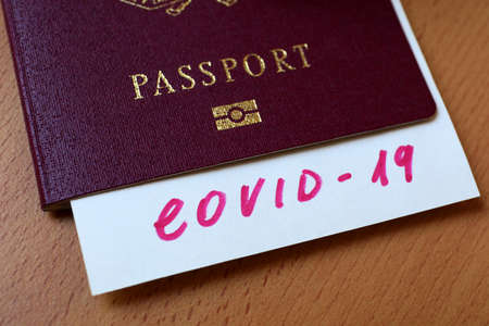 Travel and coronavirus concept, a COVID-19 note in tourist passport. Medical test at border control due to COVID. Business and tourism hit by corona virus, restrictions during coronavirus pandemic.の写真素材