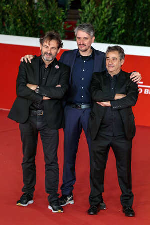 Rome, Italy - October 15, 2021: The cast of the film Mediterraneo - The Law of the Sea, walk red carpet at the Rome Film Festival. From left Oscar Camp, founder of Open Arms, Marcel Barrena the Spanish director, and actor Eduard Fernandez.のeditorial素材