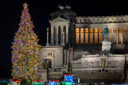 Rome, Italy - December 12, 2021: Christmas tree in Piazza Venezia, Christmas decorations and lights decorate the whole square, in the background the National Monument to King Vittorio Emanuele II.のeditorial素材