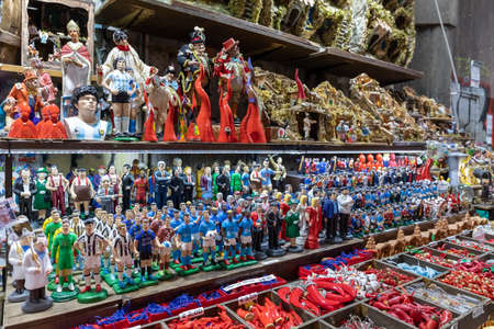Naples, Italy - December 24, 2021: Stall for the sale of handmade statuettes representing famous celebrities, sports, politics, music and religion, in San Gregorio Armeno, a famous street for the sale of religious and celebratory nativity scenes and statuのeditorial素材