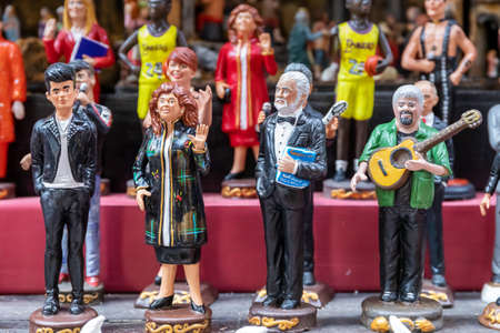 Naples, Italy - December 24, 2021: Hand painted terracotta statuettes, representing famous people, for sale in San Gregorio Armeno, the famous street of Christmas gifts.のeditorial素材