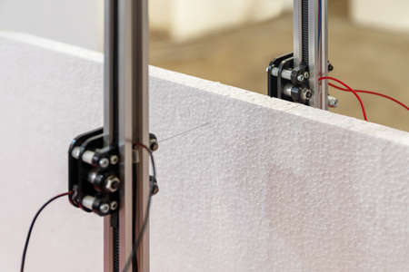 The cutter is a plotter that uses the hot wire technique for cutting polystyrene. It creates shapes starting from images and silhouettes and is controlled by computer software.の写真素材