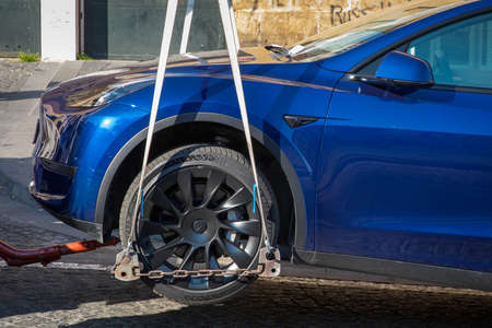 Naples, Italy - March 25, 2022: Removal with the tow truck of a parked car in no parking. Fine and...