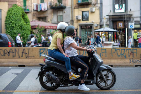 Naples, Italy - May 25, 2022: The citizens of Naples love to move around the city using the moped as...