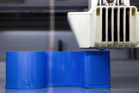 3D printer in operation. 3D printing of a geometric figure using ABS material, plastic polymers.の写真素材