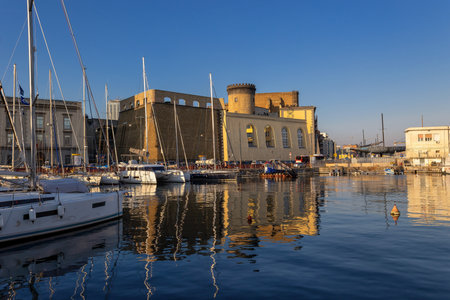 Naples, Italy - February 15, 2023: The Aragonese castle taken from the small tourist port with the sailboats.のeditorial素材