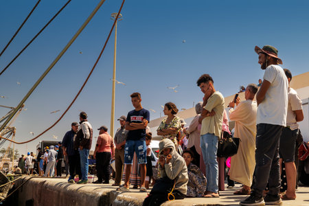 Essaouira, Morocco - August 2, 2023: On the quay of the port people wait for the fish to be unloaded so they can buy it.のeditorial素材