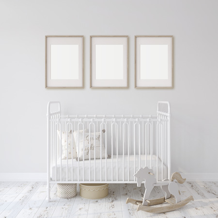 Farmhouse nursery. White metal crib near white wall. Three wooden frames on the wall. Interior and frame mockup. 3d rendering.の写真素材