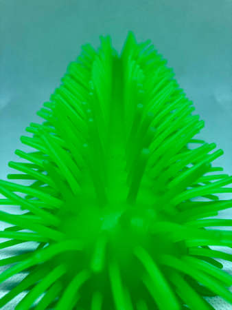 Funny green toy on a white backgroundの写真素材