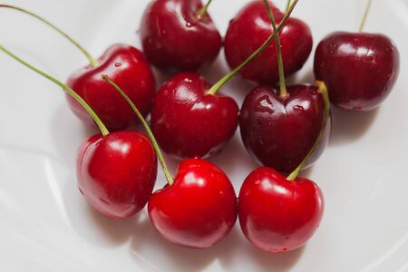 Ripe red cherries closeup on a white background