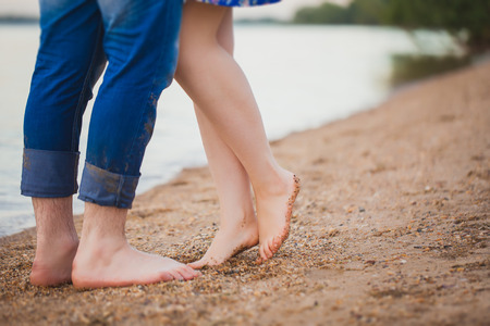 Loving couple sitting on the beach sunrizeの写真素材