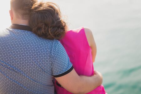 Loving couple hugging her waist close up outdoorの写真素材