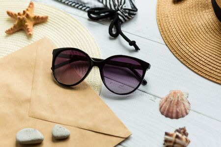 Sunglasses, hat and swimsuit on a white background. Vacation on the beach. Flatlay, top wiewの写真素材