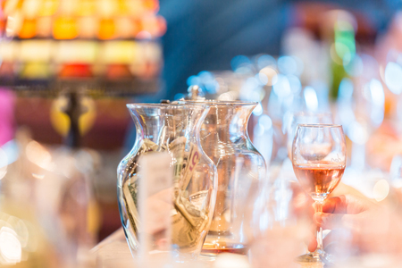 Wine tasting at colorful bar leaving tips in pitcherの写真素材