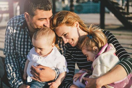 Happy stylish family spending time together outdoors.の写真素材