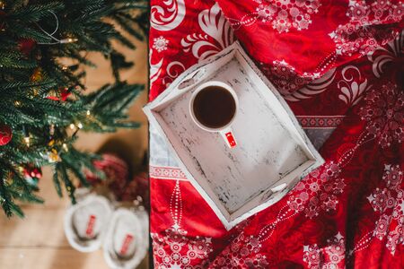 Interior with Christmas tree in a cozy bedroom. Holiday morningの写真素材