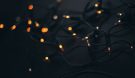 Golden Christmas garland on black background close up.の写真素材