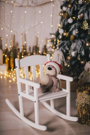 Presents under the vintage Christmas tree with festive lights on backgroundの写真素材