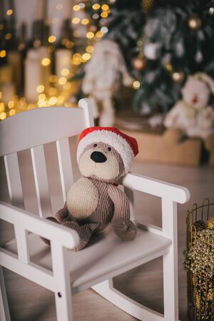 Presents under the vintage Christmas tree with festive lights on backgroundの写真素材