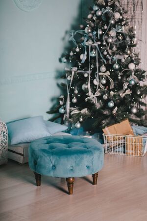 Presents under the vintage Christmas tree with festive lights on backgroundの写真素材