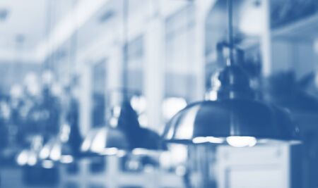 Blurred defocused image of urban lamps toned in trendy blue color of year 2020.の写真素材