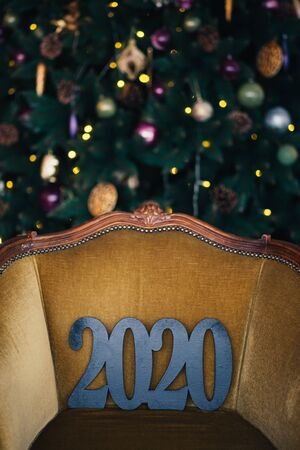 Black numbers 2020 close up with festive new year lights.