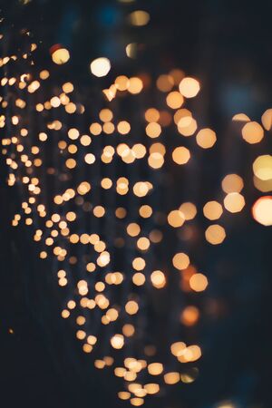 Blurred defocused Christmas lights on black background.の写真素材