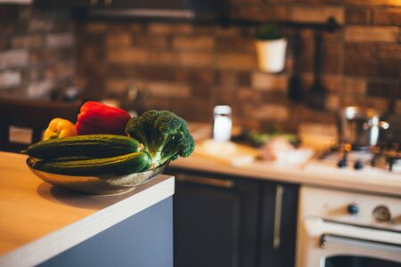 Fresh vegetables on table in modern kitchen interior.の写真素材
