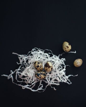 Quail eggs on black background. Easter backdrop. Place for text.の写真素材