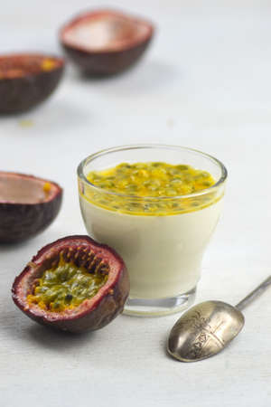 Tasty Italian dessert panna cotta with fresh passion fruits on light background. Copy spaceの写真素材