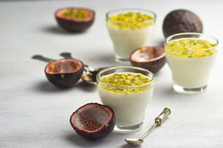 Tasty Italian dessert panna cotta with fresh passion fruits on light background. Copy spaceの写真素材