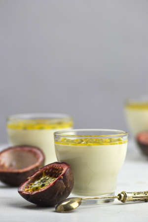 Tasty Italian dessert panna cotta with fresh passion fruits on light background. Copy spaceの写真素材