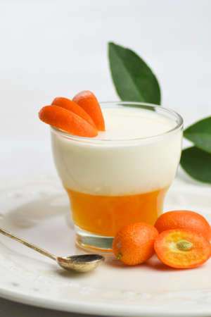 Italian dessert panna cotta with mandarin jelly on white background.の写真素材