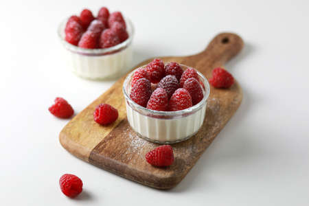 Italian dessert panna cotta with raspberries on white background.の写真素材