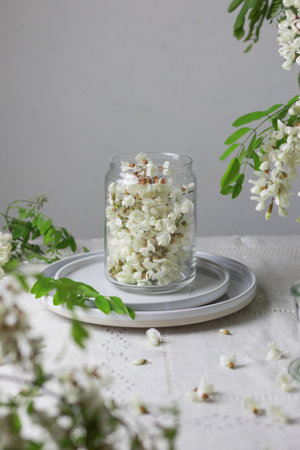 Acacia flowers in a jar on gray background.の写真素材