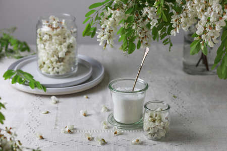 Acacia flowers and sugar in a jars on gray background.の写真素材